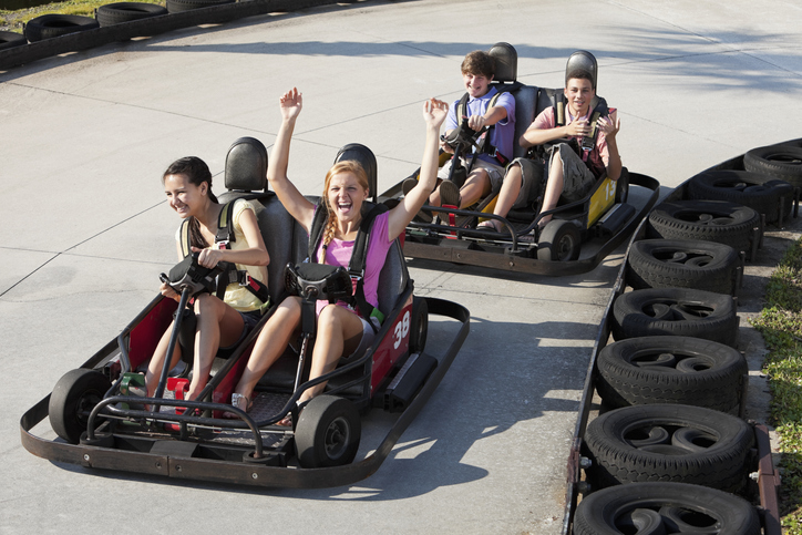 teenagers riding go-carts